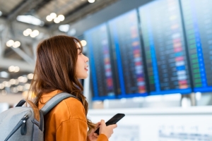 Woman looking at Flight check in board