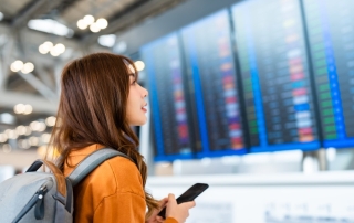 Woman looking at Flight check in board