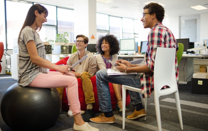 Colleagues discussing wellbeing in office
